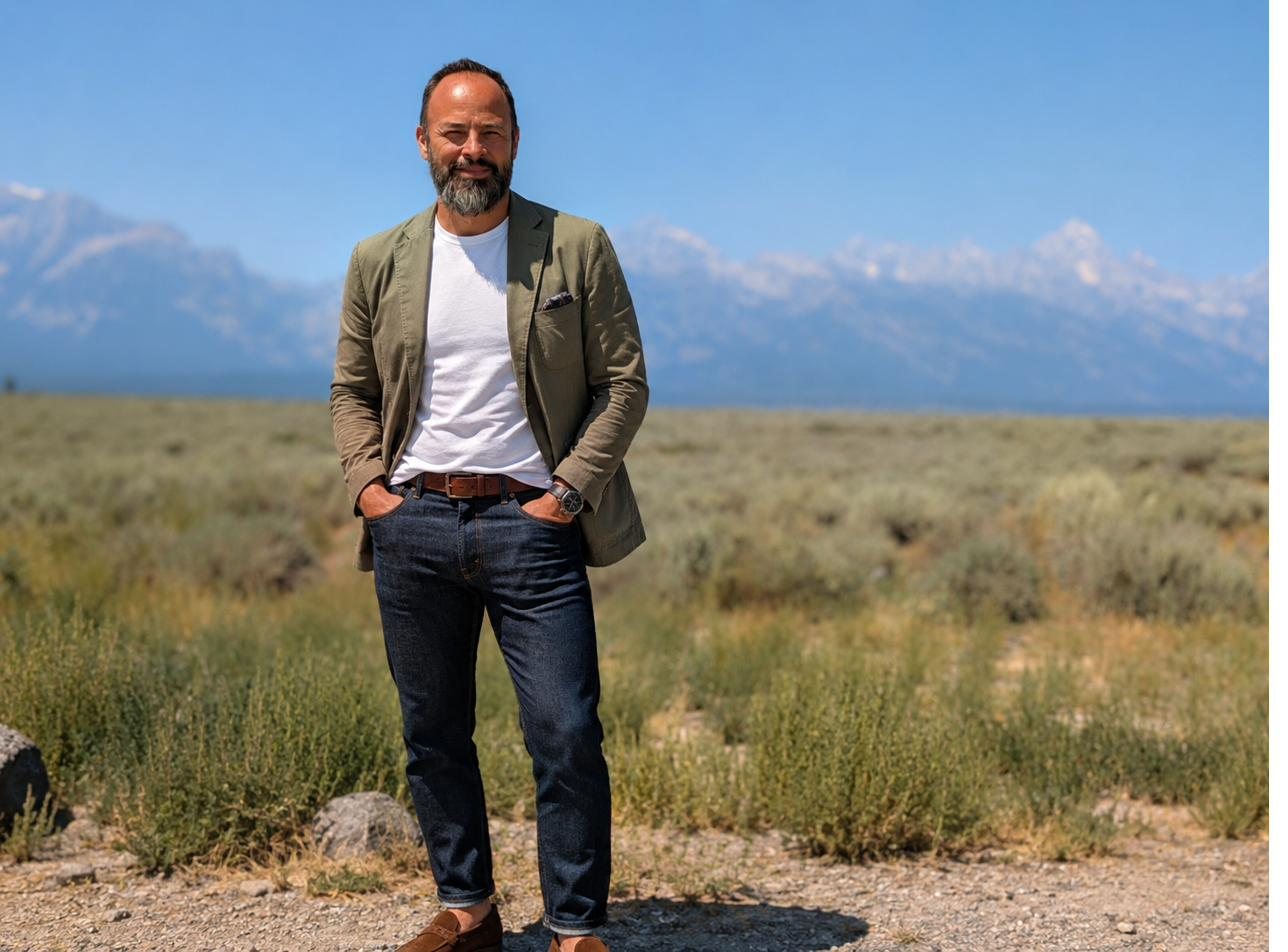Omar Treviño standing outdoors with a mountain range behind him